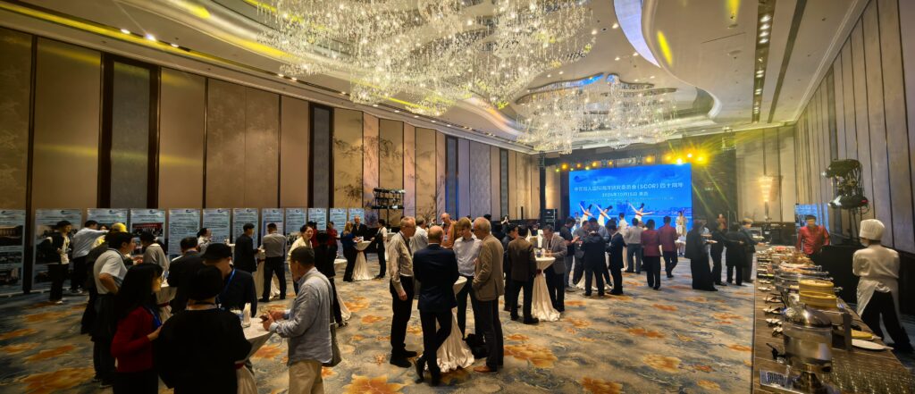 People mingling in a hotel ballroom.